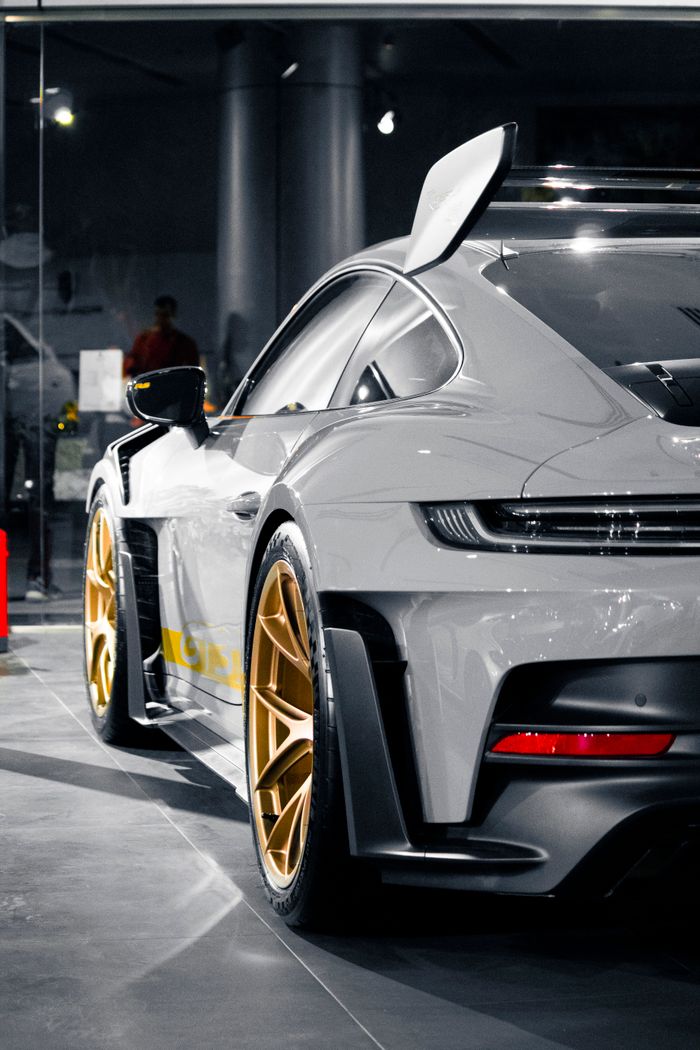 High-angle view of a luxury sports car showcasing its design and golden rims.